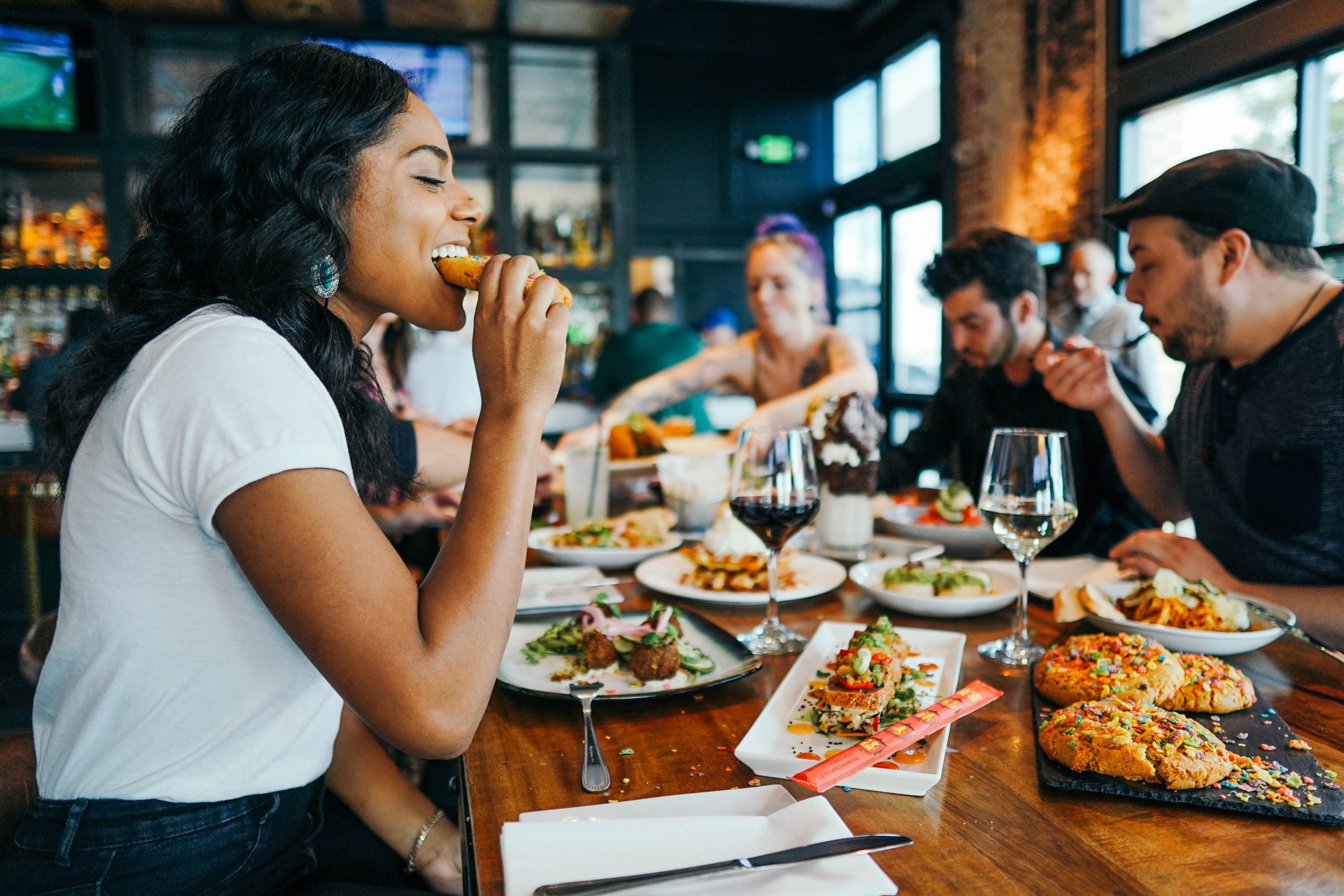 Woman eating food at a table at a restaurant